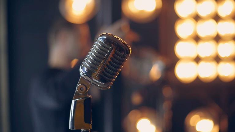 Retro microphone on stage. Silver microphone in vintage style